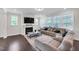 Comfortable living area with a fireplace, large sectional, and plenty of windows offering natural light at 1051 Jura Ridge Dr, Fuquay Varina, NC 27526
