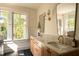 Modern bathroom featuring marble countertops, stylish fixtures, and natural light at 1113 Mordecai Dr, Raleigh, NC 27604