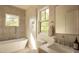 Bright bathroom featuring a sleek tub, stylish tiling, and modern fixtures at 1113 Mordecai Dr, Raleigh, NC 27604