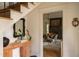 Bright foyer with black and white tile floors, decorative mirror, and a view into the dining room at 1113 Mordecai Dr, Raleigh, NC 27604