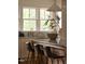Kitchen island with bar seating, marble countertops, and stainless steel appliances, illuminated by natural light at 1113 Mordecai Dr, Raleigh, NC 27604