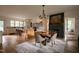 Open-concept kitchen and dining area with a large island, modern appliances, and a striking fireplace at 1113 Mordecai Dr, Raleigh, NC 27604