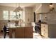 Bright kitchen featuring white cabinetry, marble countertops, a large island, and stainless steel appliances at 1113 Mordecai Dr, Raleigh, NC 27604