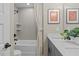 Well-lit bathroom featuring a tiled shower-tub combination and a vanity with framed art at 1165 Tembrook Dr, Mebane, NC 27302
