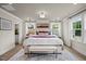 Bright main bedroom featuring large windows, hardwood floors, and designer decor at 1165 Tembrook Dr, Mebane, NC 27302