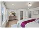 Spacious main bedroom featuring a large bed, hardwood floors, and an ensuite bathroom at 1165 Tembrook Dr, Mebane, NC 27302