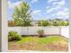Fenced backyard with green grass, mulch landscaping and view of houses in the neighborhood at 1208 Brown Velvet Ln, Apex, NC 27523