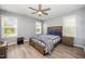 Cozy bedroom with a wooden bed frame, ceiling fan and lots of natural light at 1208 Brown Velvet Ln, Apex, NC 27523