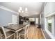 Inviting dining area adjacent to kitchen featuring hardwood floors and modern lighting at 1208 Brown Velvet Ln, Apex, NC 27523