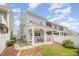Rear exterior showcasing a covered patio with a ceiling fan and a fenced backyard at 1208 Brown Velvet Ln, Apex, NC 27523