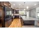 Granite countertops and stainless appliances create an inviting kitchen with wood flooring at 1208 Brown Velvet Ln, Apex, NC 27523