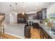 Modern kitchen with granite countertops, stainless steel appliances, and a center island at 1208 Brown Velvet Ln, Apex, NC 27523