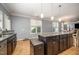 Modern kitchen features stainless appliances, granite countertops, and an island with pendant lighting at 1208 Brown Velvet Ln, Apex, NC 27523