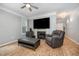 Cozy living room with fireplace, ceiling fan and TV at 1208 Brown Velvet Ln, Apex, NC 27523