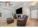 Cozy living room features a fireplace and comfortable seating with hardwood flooring at 1208 Brown Velvet Ln, Apex, NC 27523