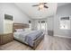 Spacious main bedroom features vaulted ceilings, ceiling fan, with two windows and a king-sized bed at 1208 Brown Velvet Ln, Apex, NC 27523