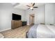 Spacious main bedroom featuring vaulted ceilings and windows that offer natural light, TV and Dresser at 1208 Brown Velvet Ln, Apex, NC 27523