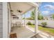 Covered patio with seating and views of the fenced backyard at 1208 Brown Velvet Ln, Apex, NC 27523