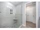 Walk-in shower with modern glass door, tiled walls, and a built-in seat at 1208 Brown Velvet Ln, Apex, NC 27523