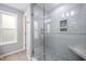 Walk-in shower with modern glass door, tiled walls, and a built-in seat, next to a window at 1208 Brown Velvet Ln, Apex, NC 27523