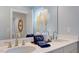 Stylish bathroom featuring a double vanity with modern faucets and decorative vases, creating an elegant and functional space at 121 Seagraves Creek Ln, Holly Springs, NC 27540