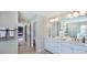 Bathroom featuring double sinks, white cabinets, and walk in shower viewed from hallway at 121 Seagraves Creek Ln, Holly Springs, NC 27540