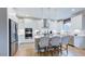 Modern kitchen with stainless steel appliances, white cabinets, and center island with seating at 121 Seagraves Creek Ln, Holly Springs, NC 27540