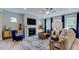 Cozy living room featuring a fireplace, television and comfortable seating area at 121 Seagraves Creek Ln, Holly Springs, NC 27540