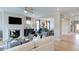 Bright living room with fireplace and view into dining area with decorative mirror and white crown molding at 121 Seagraves Creek Ln, Holly Springs, NC 27540