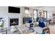 Cozy living room with fireplace and view into dining room with neutral color palette at 121 Seagraves Creek Ln, Holly Springs, NC 27540