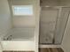Bathroom featuring a shower, bathtub, and window at 128 Oakfield Trace Dr, Four Oaks, NC 27524