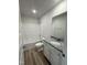 Bathroom featuring a shower-tub combo, decorative mirror, and granite counters at 128 Oakfield Trace Dr, Four Oaks, NC 27524