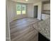 Bright dining area adjacent to kitchen features hardwood-style flooring and backyard views at 128 Oakfield Trace Dr, Four Oaks, NC 27524
