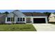 Attractive one-story house showcasing a manicured lawn, black garage door, and simple landscaping at 128 Oakfield Trace Dr, Four Oaks, NC 27524