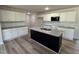 Updated kitchen featuring white cabinets, granite countertops, a center island and wood floors at 128 Oakfield Trace Dr, Four Oaks, NC 27524