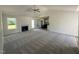 Open living area with carpet, a fireplace, backyard access, and adjoins an island kitchen at 128 Oakfield Trace Dr, Four Oaks, NC 27524