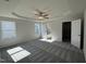 Spacious bedroom featuring a tray ceiling, ceiling fan, neutral paint, and plush carpeting at 128 Oakfield Trace Dr, Four Oaks, NC 27524