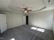 Bright bedroom featuring plush carpeting, neutral paint, and a ceiling fan at 128 Oakfield Trace Dr, Four Oaks, NC 27524