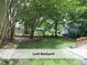 View of the lush backyard, perfect for outdoor activities and relaxation at 1410 Shawnee St, Durham, NC 27701