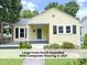 Inviting yellow bungalow featuring a large front porch expanded with composite flooring in 2021 at 1410 Shawnee St, Durham, NC 27701