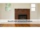 Charming brick fireplace with mantel and windows, creating a cozy focal point at 1410 Shawnee St, Durham, NC 27701