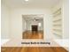 Open view of living room with fireplace and built-in shelving detail at 1410 Shawnee St, Durham, NC 27701