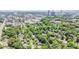 Scenic aerial view showcasing a suburban neighborhood with dense trees and downtown skyline at 1414 Park Dr, Raleigh, NC 27605