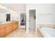 Bathroom featuring double vanities, soaking tub, and access to other rooms at 1414 Park Dr, Raleigh, NC 27605