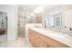 Beautiful bathroom with a double sink vanity, glass shower, and neutral tile at 1414 Park Dr, Raleigh, NC 27605