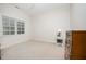 Clean bedroom features a window and neutral carpet, dresser, and side table at 1414 Park Dr, Raleigh, NC 27605