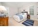 Well-lit bedroom with windows, hardwood furniture, white bedding, and a blue accent rug at 1414 Park Dr, Raleigh, NC 27605