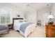 Bright bedroom with hardwood furniture, white bedding, and a comfortable rocking chair at 1414 Park Dr, Raleigh, NC 27605