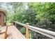 Spacious wooden deck with black metal railings offering a serene outdoor living space at 1414 Park Dr, Raleigh, NC 27605