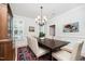 Formal dining room with a dark wood table, light upholstered chairs, and a chandelier at 1414 Park Dr, Raleigh, NC 27605